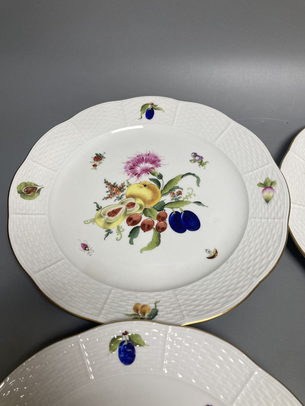 A set of four Herend Meissen style floral painted dessert dishes, diameter 25.5cm